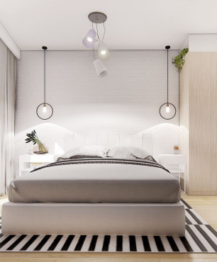 Sypialnia z łóżkiem kontynentalnym i dywanem w biało-czarne paski