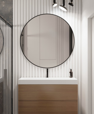 Łazienka z dużym okrągłym lustrem w czarnej oprawie