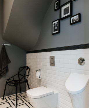Łazienka ze skosem sufitowym w kolorze szarym i z białymi płytkami na połowie ściany od ziemi