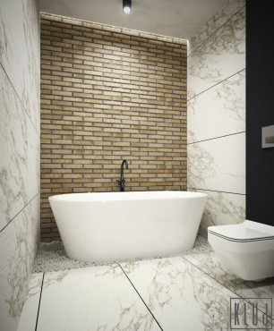 Piękna łazienka z cegłą na jednej ścianie oraz z wolnostojąca wanną ceramiczną