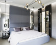 Sypialnia z łóżkiem kontynentalnym oraz panelem tapicerowanym na ścianie