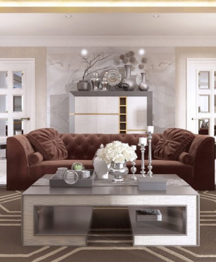 Szykowny salon z brązową sofą oraz szklanym, prostokątnym stolikiem