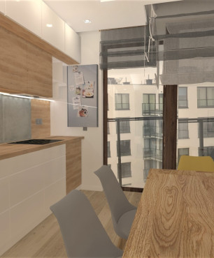 Kuchnia w zabudowie z betonem architektonicznym nad drewnianym blatem połączona z jadalnią
