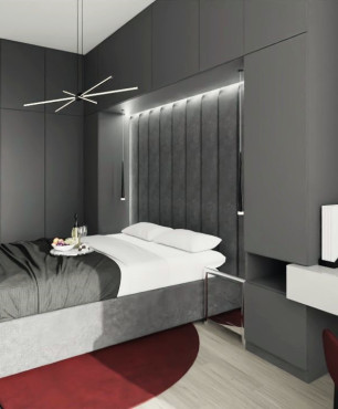 Sypialnia z tapicerowanym, składanym łóżkiem oraz z tapetą na ścianie